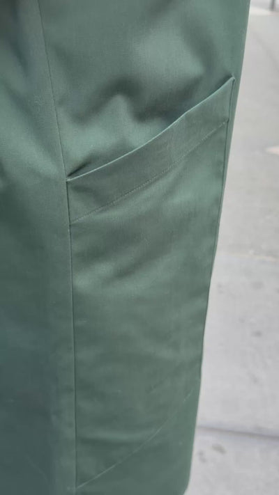 A video of the deep, functional pocket on a green dress.